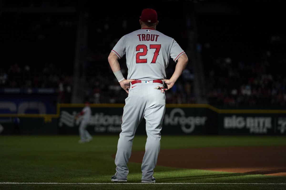 Sunlight illuminates back of Angels' Mike Trout's uniform before a game.