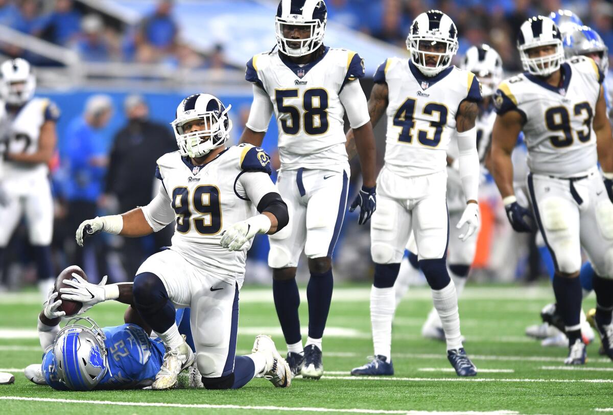 The Rams' Aaron Donald drops Detroit Lions running back Theo Riddick after a short gain in the first quarter at Ford Field in Detroit on Sunday.