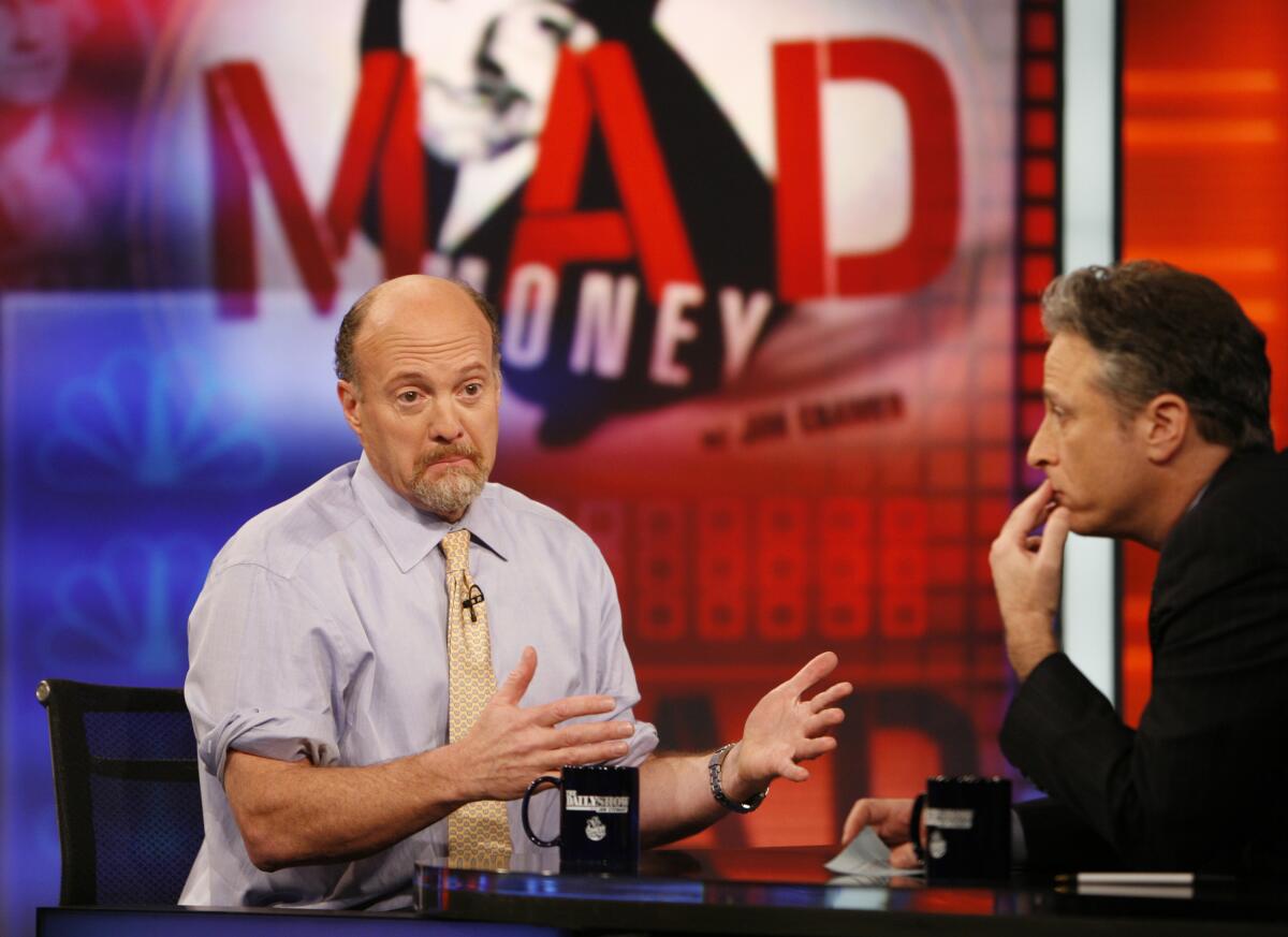 Jim Cramer, left, host of the "Mad Money" show on CNBC, talks with Jon Stewart during an appearance 