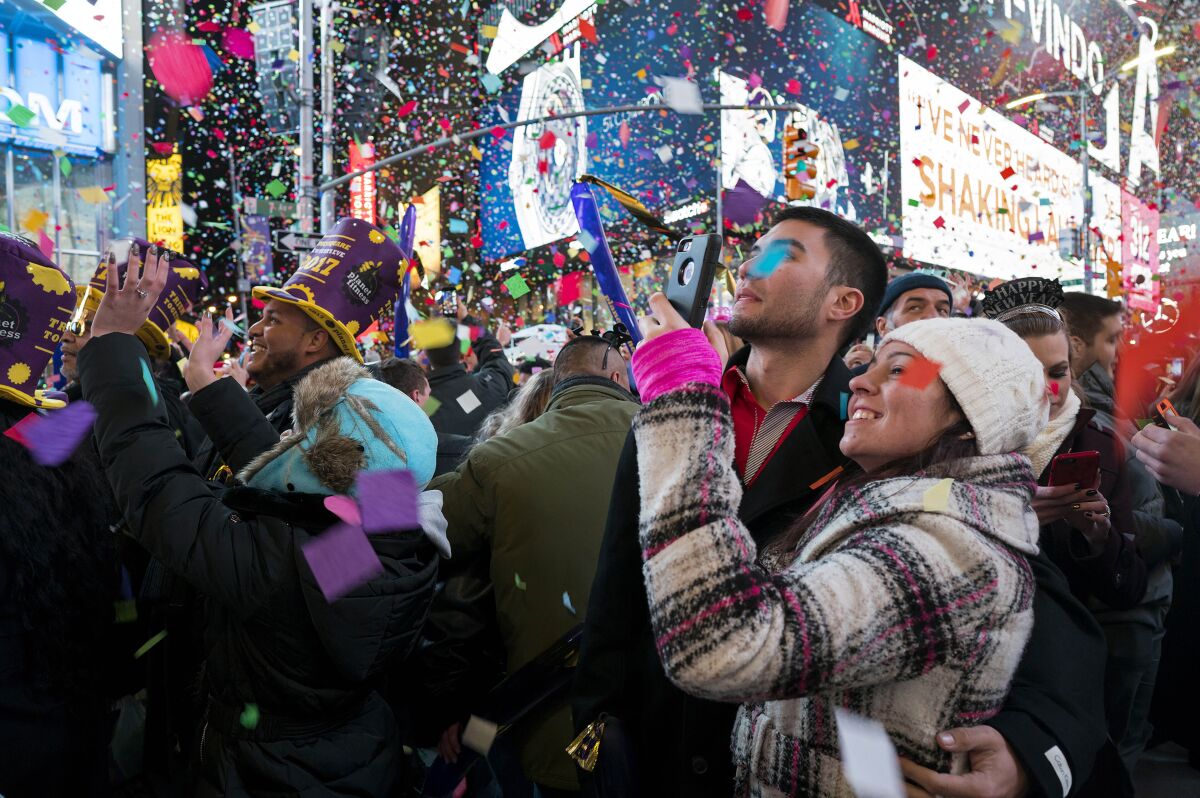 FILE — Confetti falls as people celebrate the new year in New York's Times Square, Jan. 1, 2017. Crowds will once again fill New York's Times Square this New Year's Eve, with proof of COVID-19 vaccination required for revelers who want to watch the ball drop in person, Mayor Bill de Blasio announced Tuesday, Nov. 16, 2021. (AP Photo/Craig Ruttle, File)