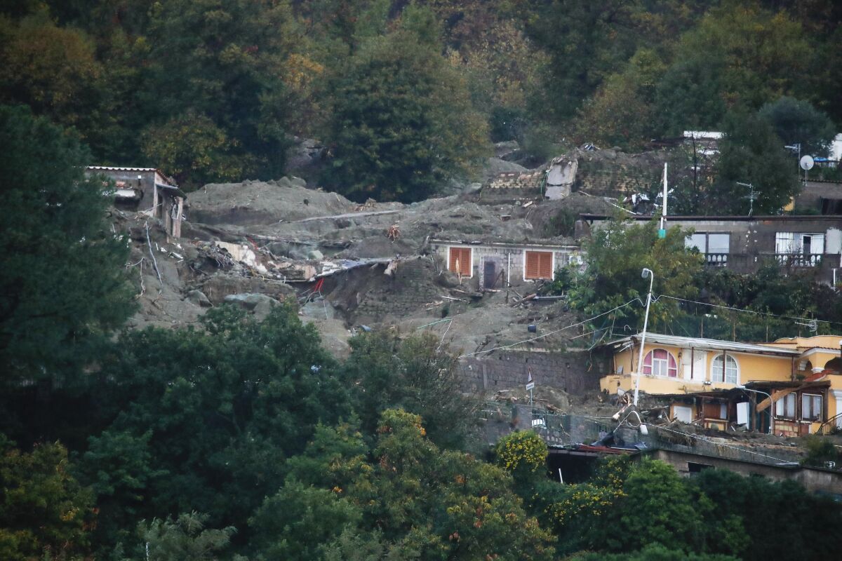 Homes are covered in mud after a heavy rainfall triggered landslides that collapsed buildings.