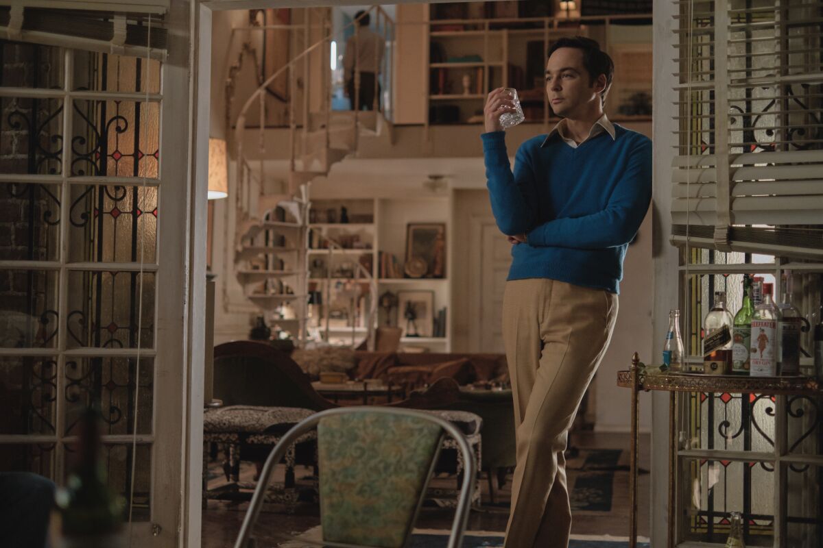 Jim Parsons as Michael stands in a doorway that leads to his apartment's terrace