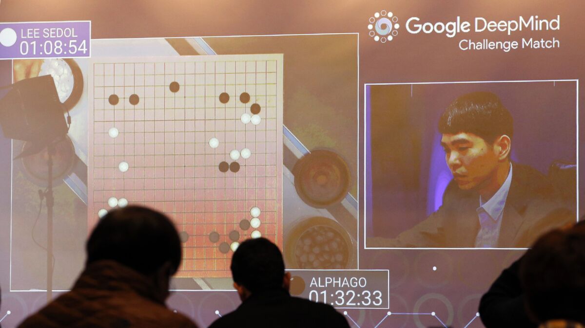 South Korean Go master Lee Sedol's match against AlphaGo is projected on a big screen in the media room of the Seoul hotel where the best-of-five contest is being played.