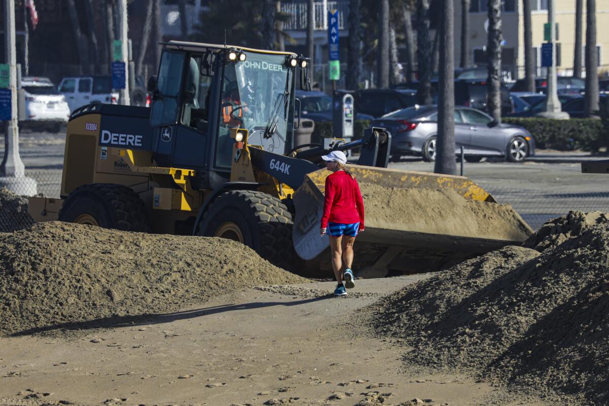 Bulldozers make sand berms near Balboa Pier.