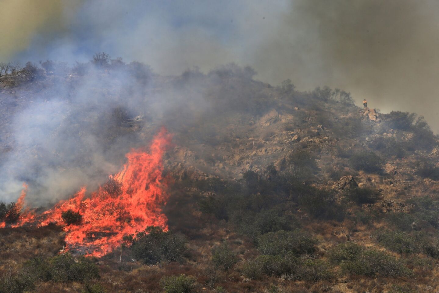 More than 280 firefighters are aided by water-dropping helicopters and fixed-wing aircraft as they battle a 1,300-acre fire in Silverado Canyon.