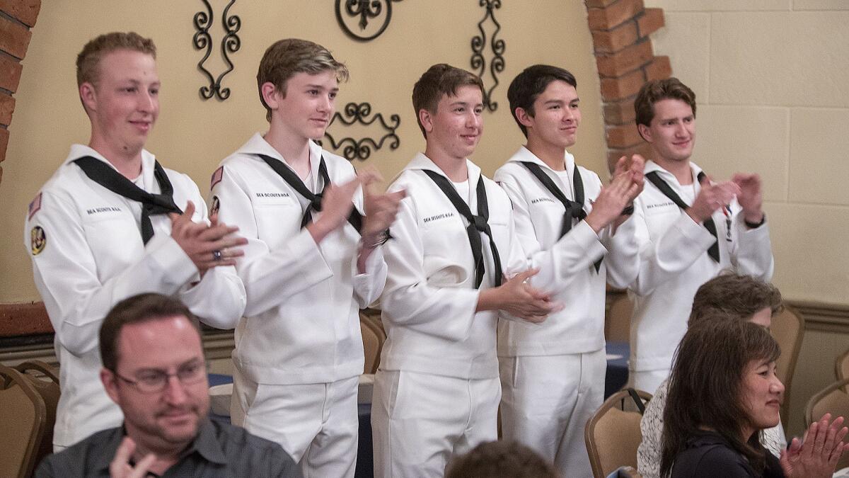 Sea Scouts applaud Mike “Skip” Stewart for his 56 years of continuous volunteer service to the organization, the maritime branch of the Boy Scouts.