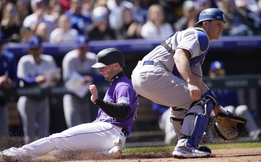 Dodgers catcher Will Smith waits for a throw as Colorado's Ryan McMahon slides into home.