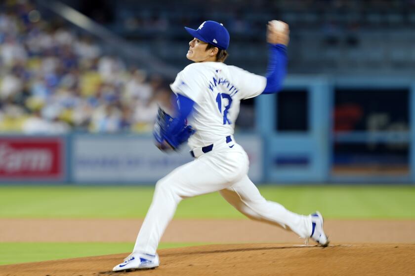 Dodgers starting pitcher Yoshinobu Yamamoto throws to the plate during the team's loss to the Cubs Tuesday 