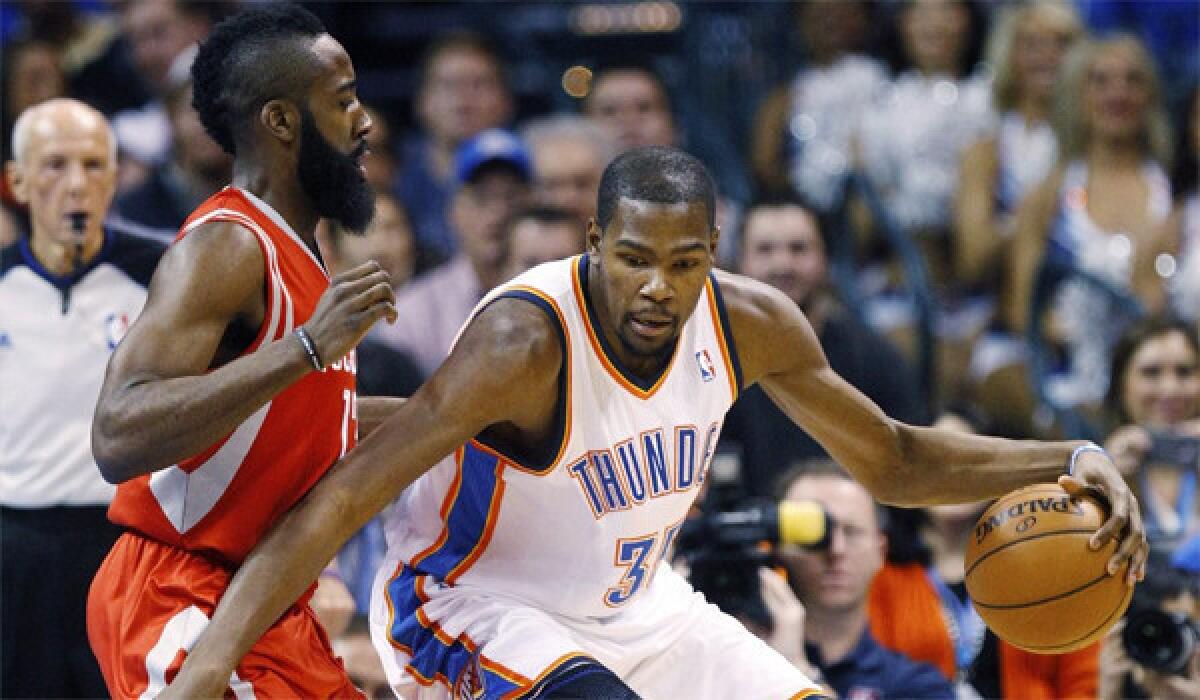 Oklahoma City Thunder forward Kevin Durant drives around James Harden during the Houston Rockets guard's first trip to Oklahoma City since the team traded him in October.