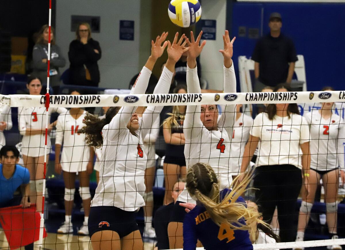 Pacifica Christian's Chara Wondercheck (8) and Kaelin Rieke (4) attempt a block in a girls' volleyball final.