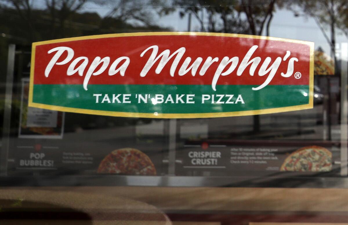 A sign in the window of a Papa Murphy's restaurant