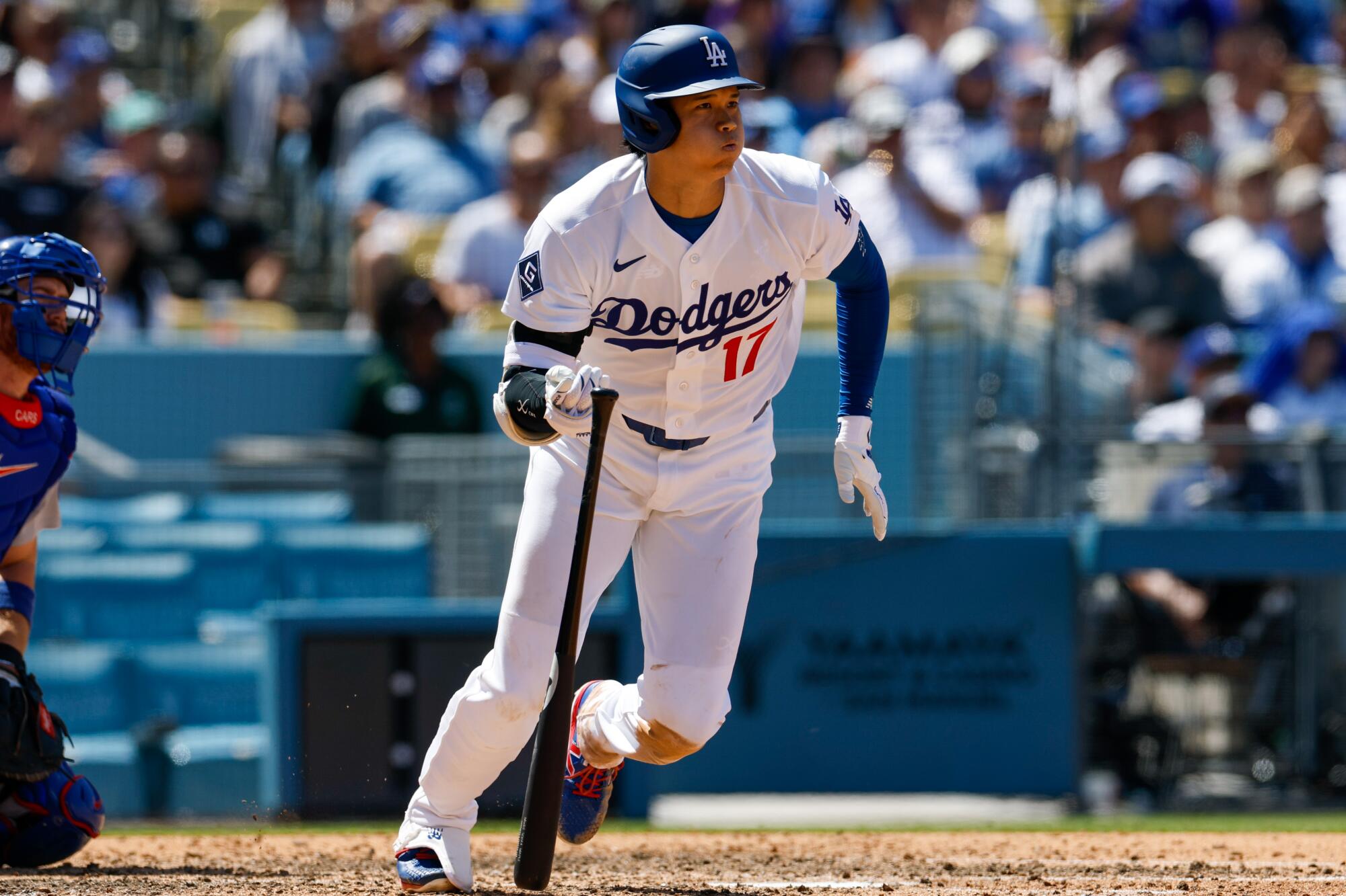 Dodgers star Shohei Ohtani hits a double in the fifth inning against the Chicago Cubs at Dodger Stadium on Sunday.