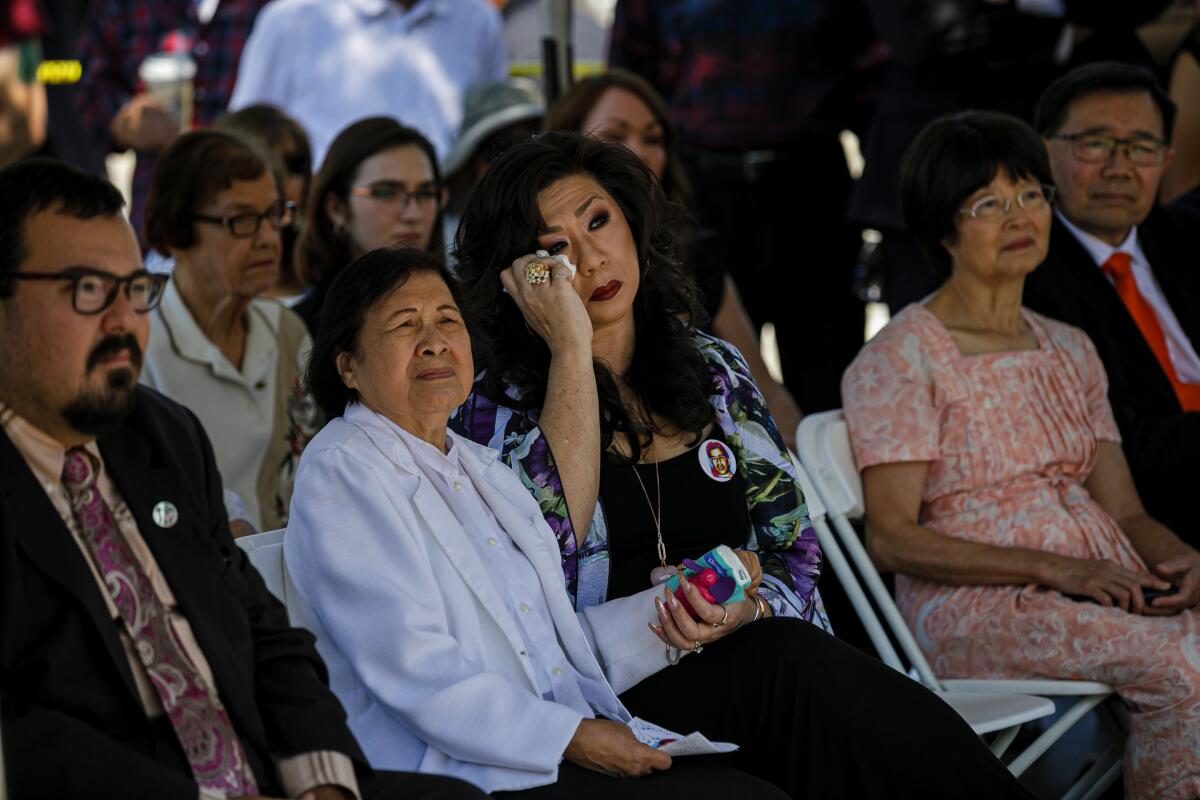 DEENA ILETO wipes her eye Saturday as she and her mother-in-law, Lilian, attend a remembrance ceremony for Lilian’s son Joseph, who was killed by a white supremacist Aug. 10, 1999, in Chatsworth. The killing of her brother-in-law was a call to action, Deena says.