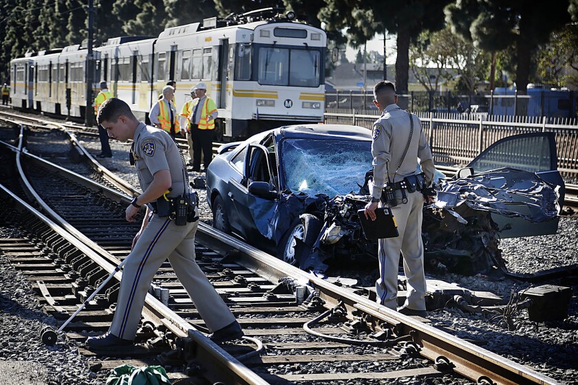 CHP and Sheriff deputies investigate a Metro Blue Line train derailed today after colliding with a passenger vehicle at Willowbrook and 119th Street in Compton.