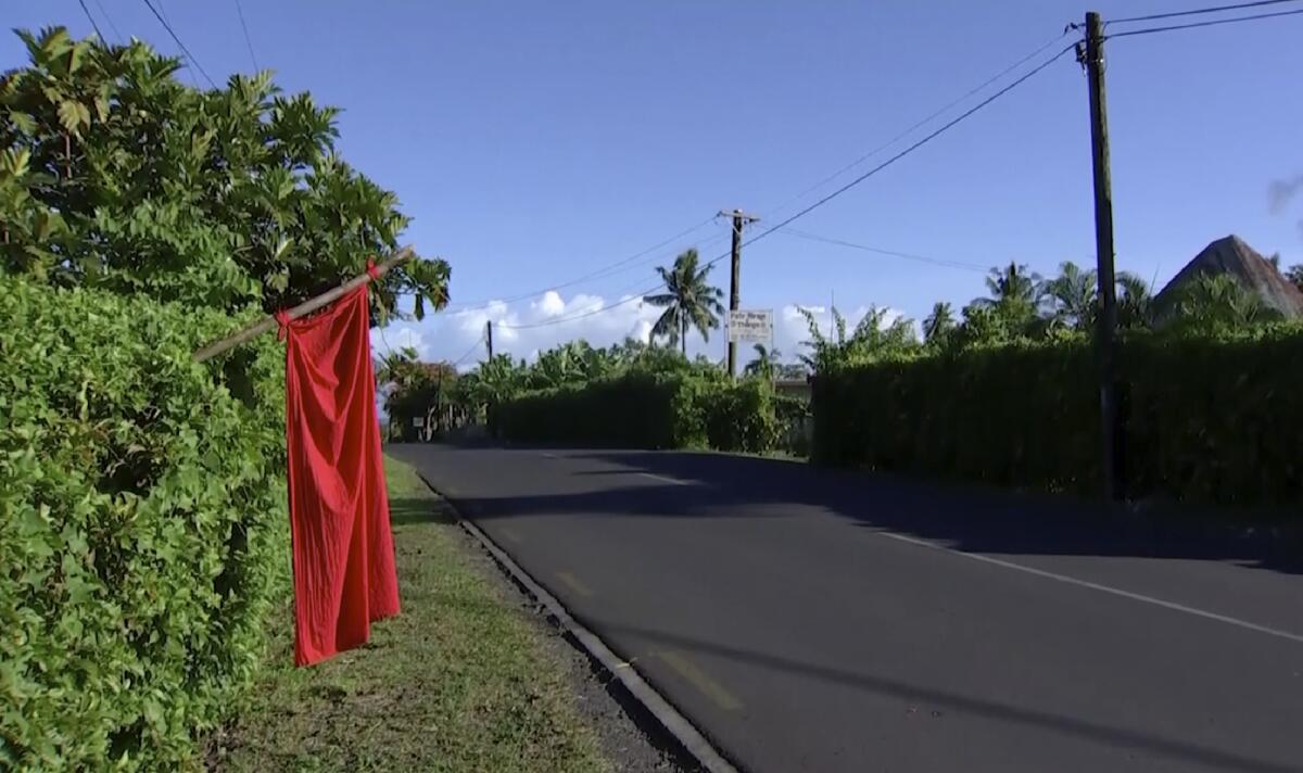 A red flag is posted outside a home in Apia, Samoa, to indicate residents need to be vaccinated.  