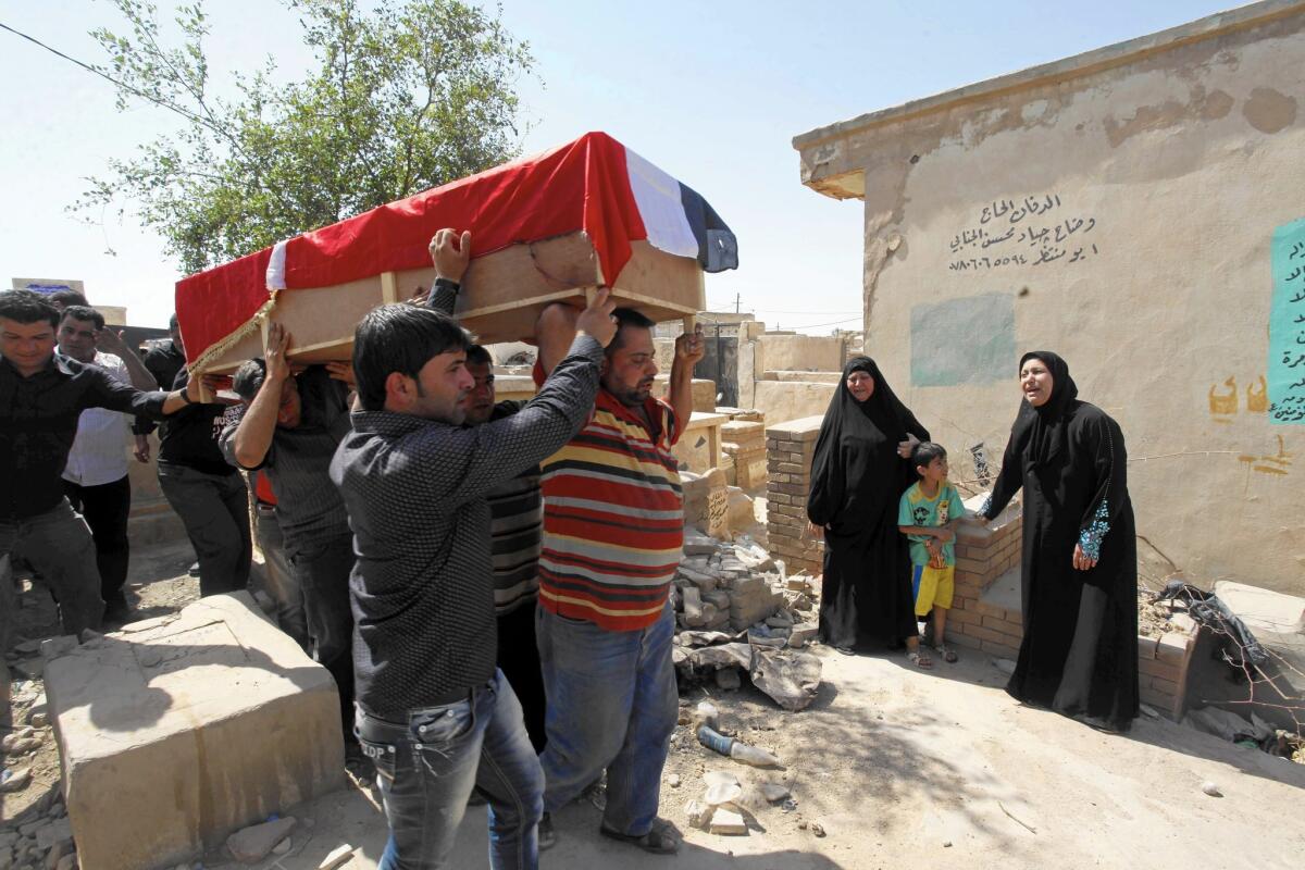 The body of bombing victim Bashar Muhsin, 28, arrives for burial in Najaf, Iraq. The prolonged conflict in Iraq has also taken a toll on morgue services, as understaffing adds to pressures on workers.