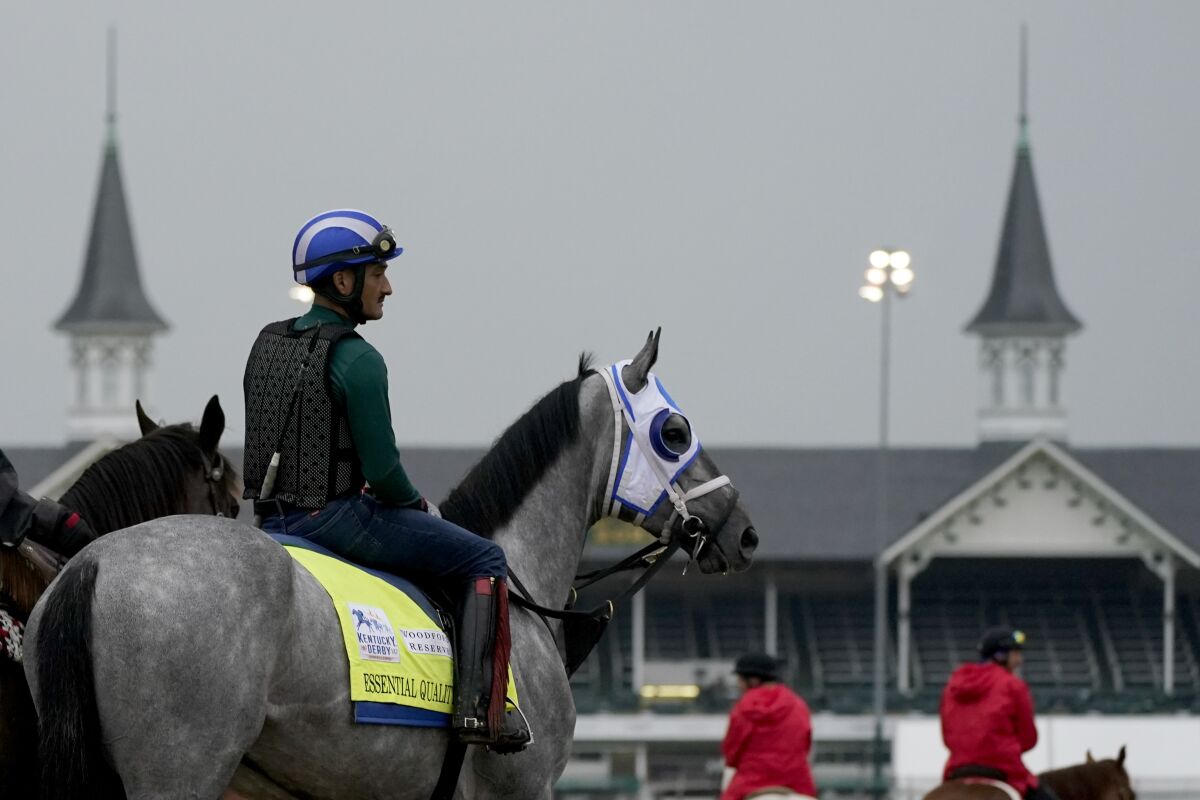 A rider sits atop Kentucky Derby entrant Essential Quality during a morning workout at Churchill Downs.