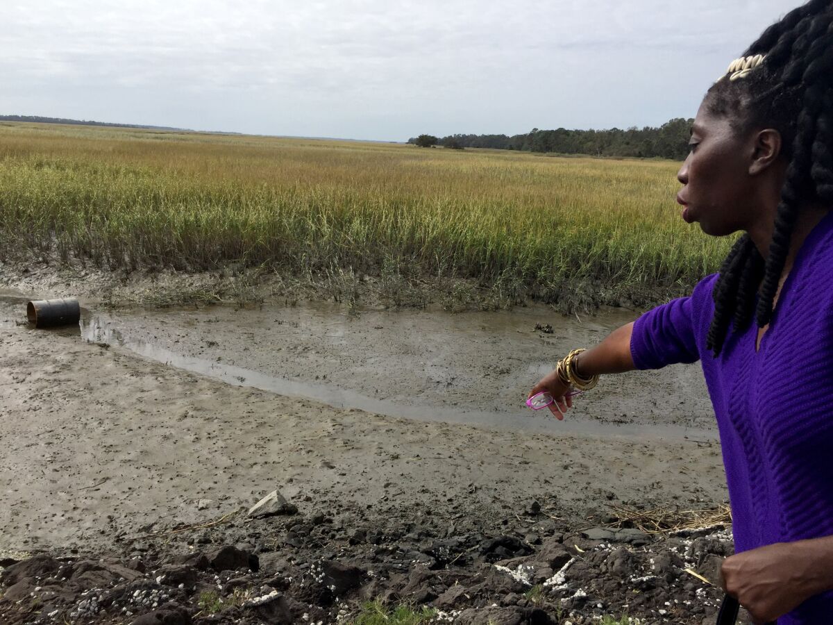 Marquetta Goodwine, chieftess of the Gullah people, points to flooding effects on the salt marshes that line the Sea Islands of South Carolina.
