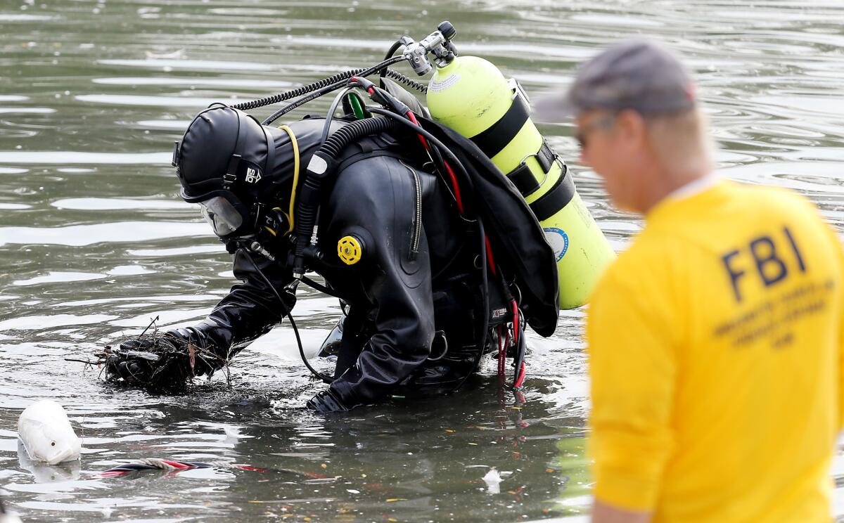 An FBI dive team searches Lake Seccombe, located about two miles north of the Inland Regional Center in San Bernardino, Dec. 10, 2015.