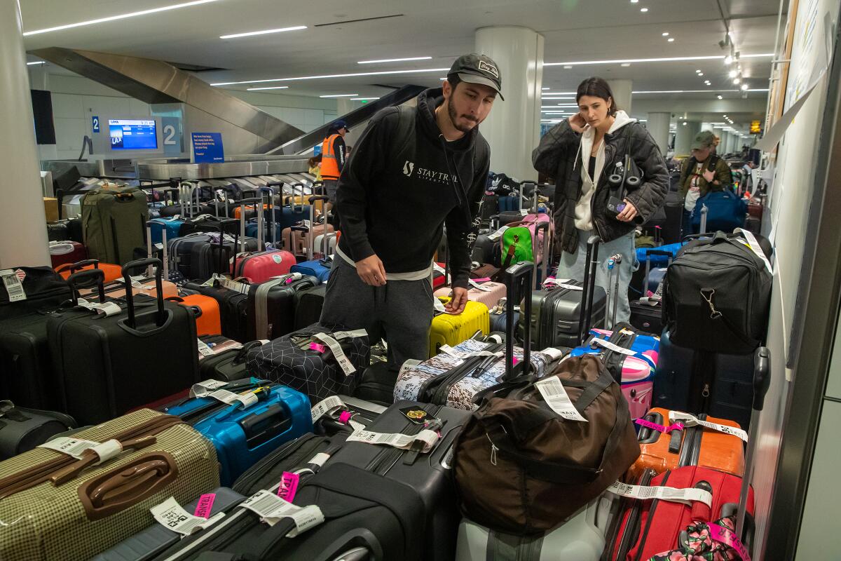 Passengers hunt for their luggage at LAX Southwest Terminal 1 