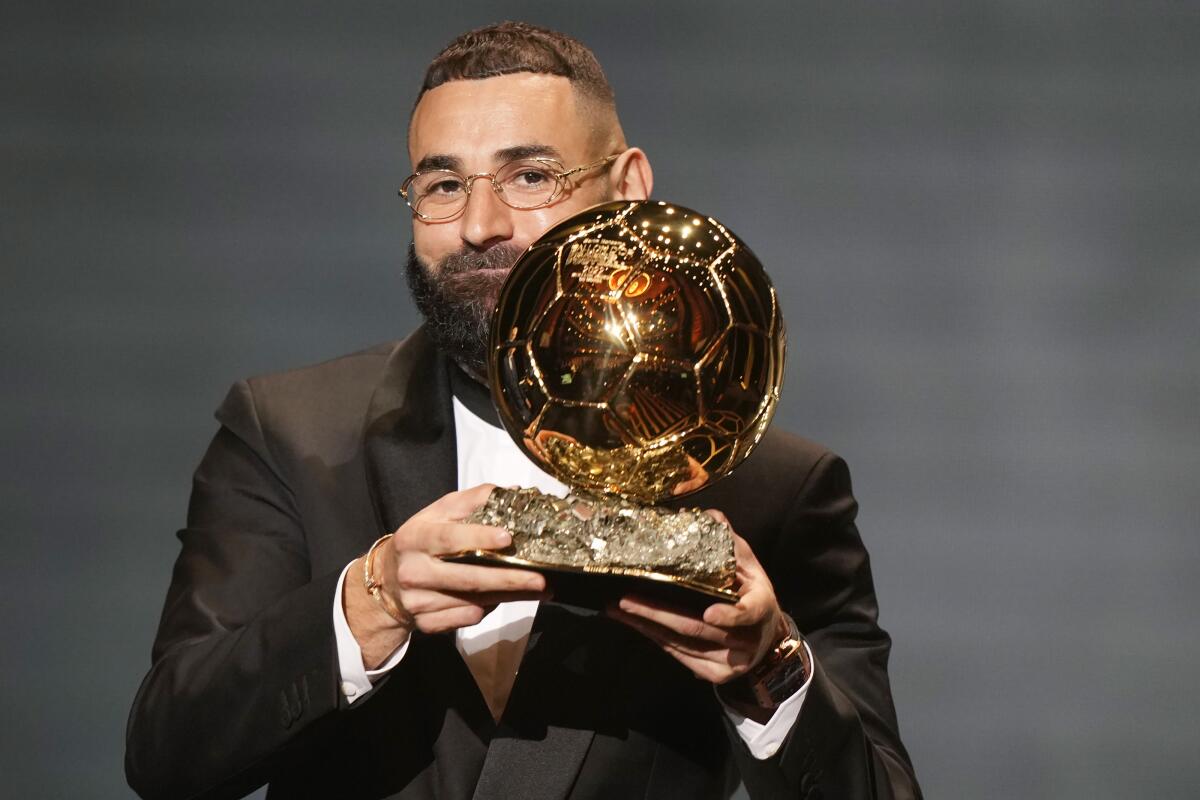 Real Madrid's Karim Benzema celebrates after winning the 2022 Ballon d'Or trophy