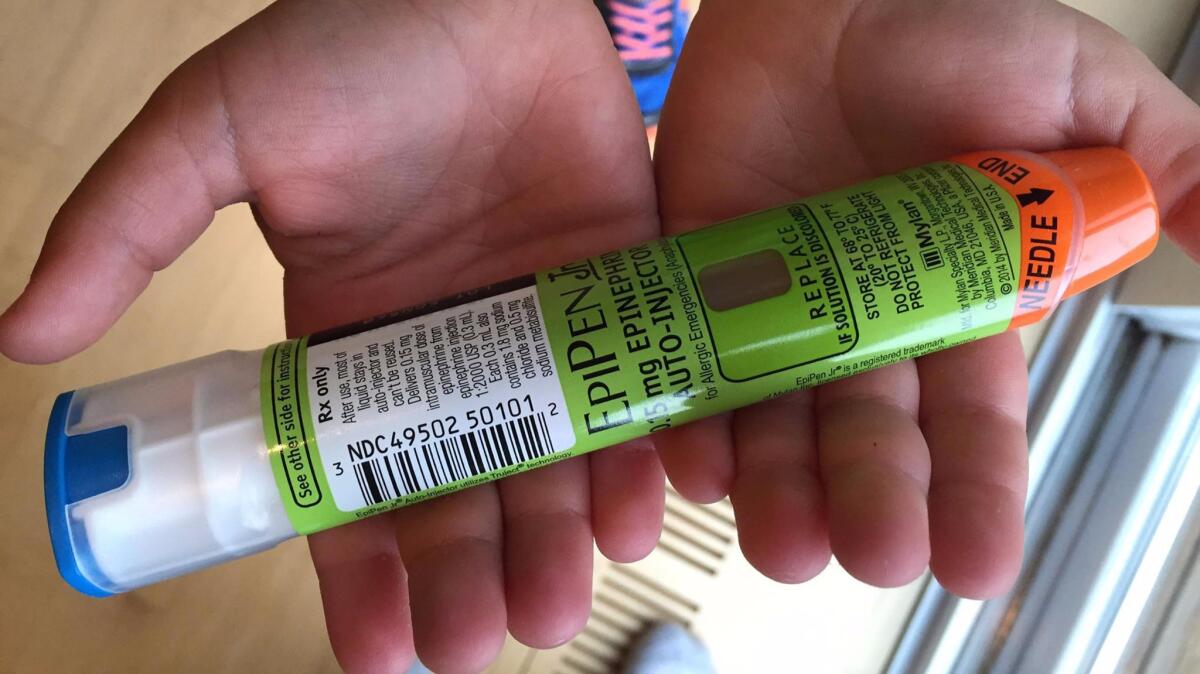 A child holds an EpiPen.