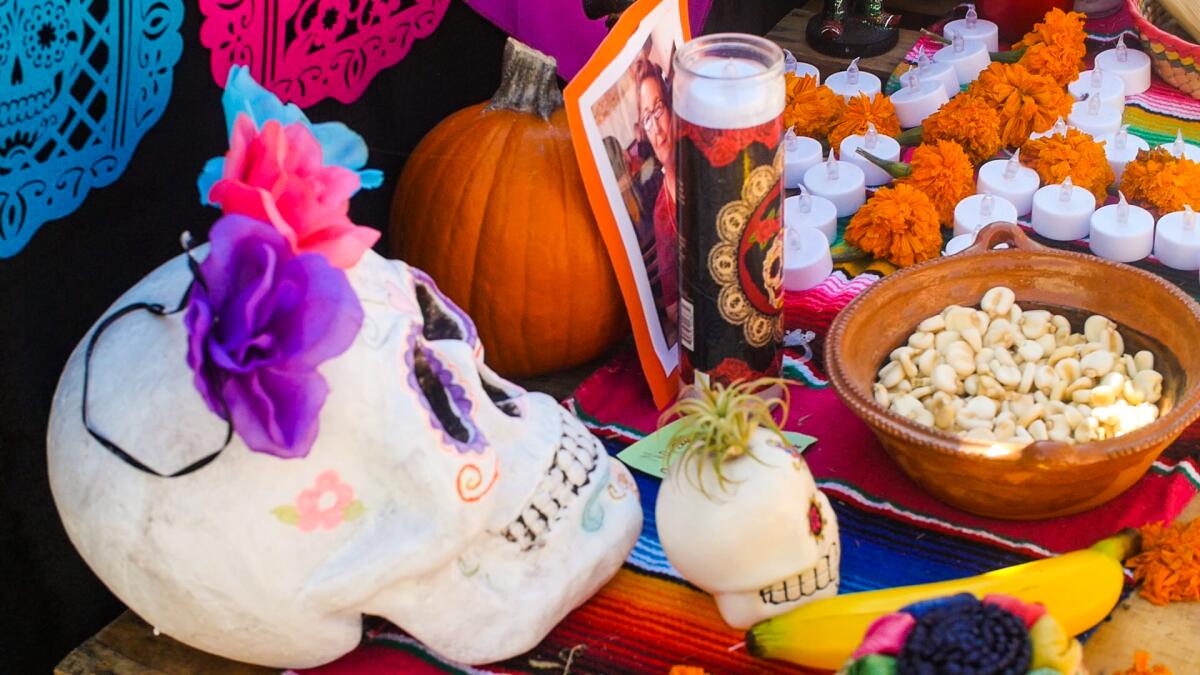 Skulls, food, and candles are offerings to honor a loved one on this altar. 