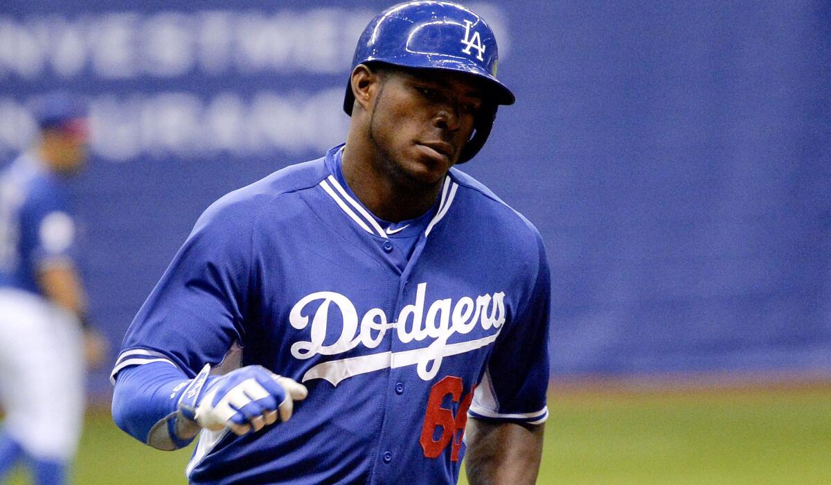 Dodgers outfielder Yasiel Puig rounds third base after hitting a three-run homer against the Rangers in the first inning of an exhibition game Friday night at the Alamodome.