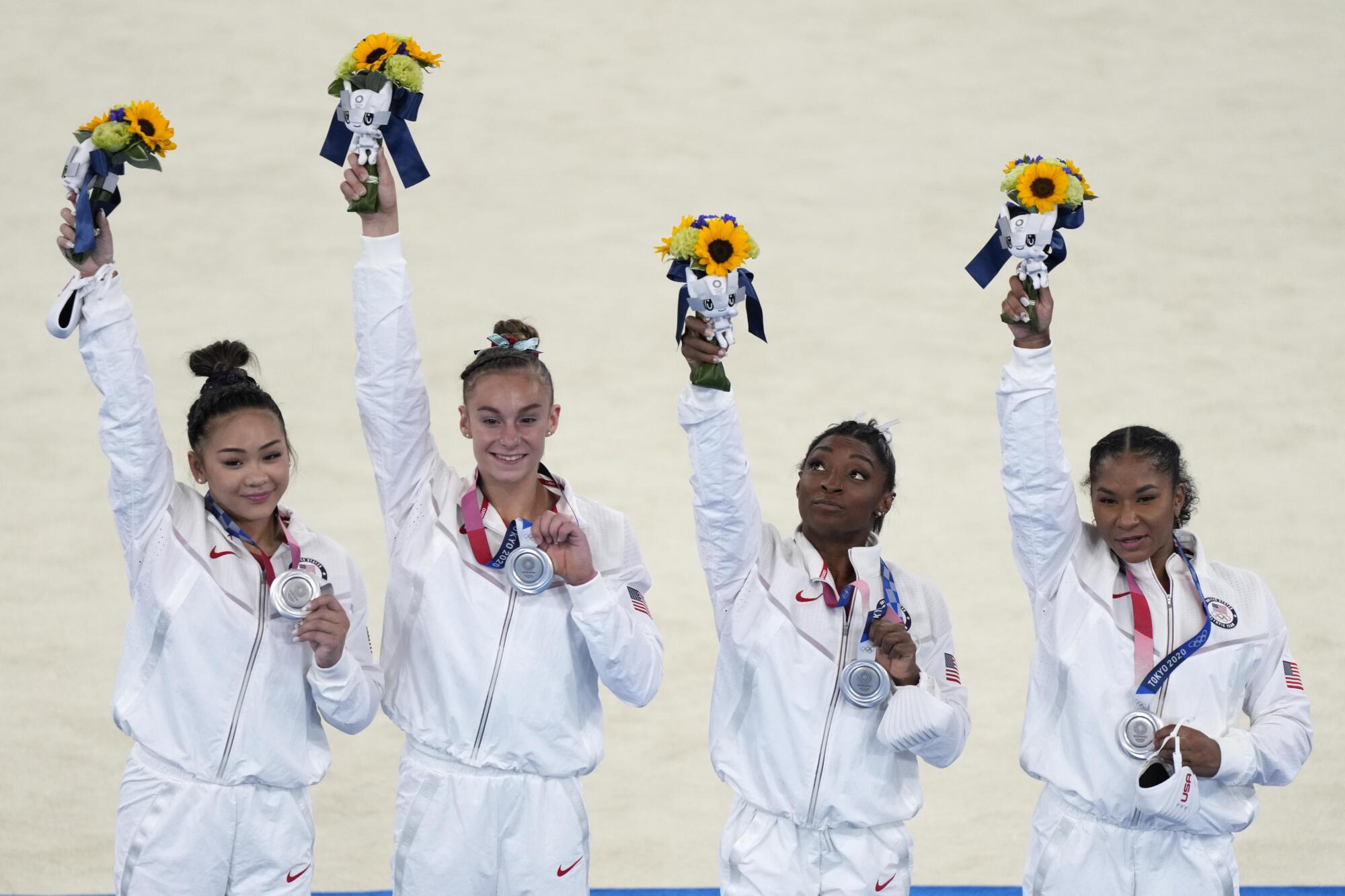 U.S. gymnasts Sunisa Lee, Grace McCallum, Simone Biles and Jordan Chiles celebrate after winning silver medals