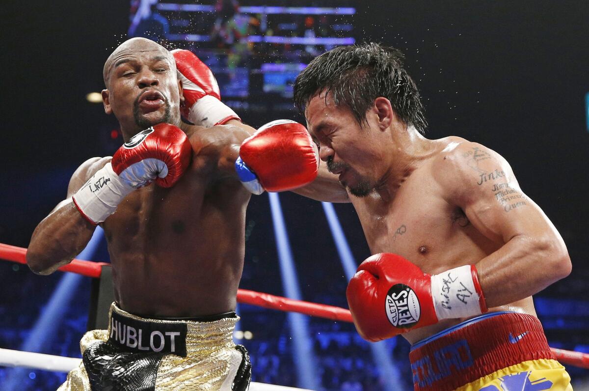Floyd Mayweather Jr. and Manny Pacquiao trade blows during their welterweight title fight on May 2, 2015.