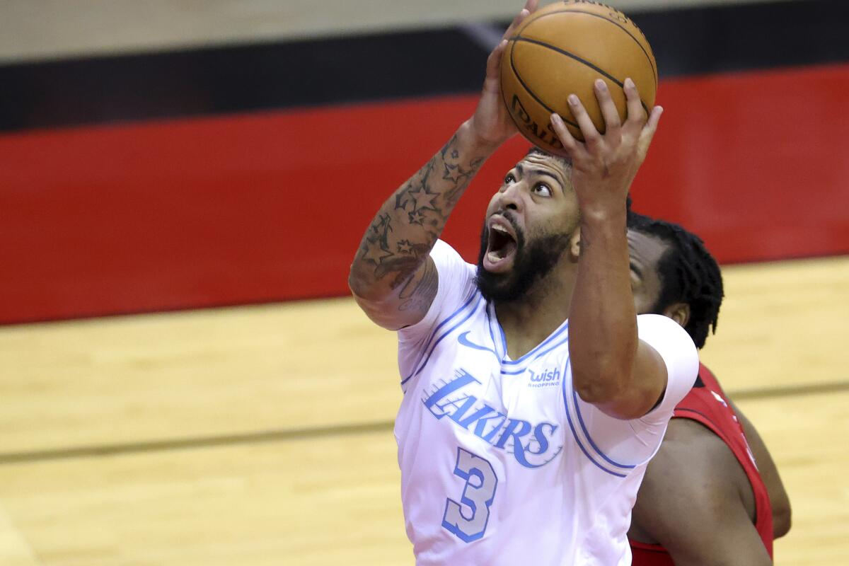 Los Angeles Lakers' Anthony Davis (3) goes up for a basket against the Houston Rockets.