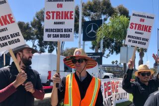 Auto technicians picket in front of the Mercedes Benz San Diego dealership in Kearny Mesa.  