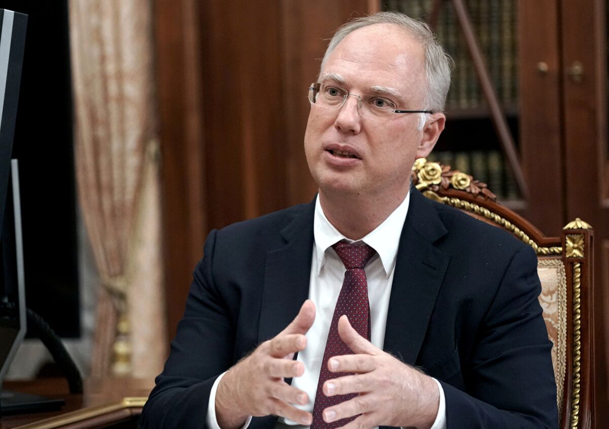FILE - In this Friday, April 2, 2021 file photo, Russian Direct Investment Fund CEO Kirill Dmitriev gestures while speaking to Russian President Vladimir Putin during their meeting in Moscow, Russia. Dmitriev said Russia plans to provide up to 300 million doses of its Sputnik vaccine to the U.N.-backed initiative, COVAX, once the vaccine is approved by the World Health Organization.(Alexei Druzhinin, Sputnik, Kremlin Pool Photo via AP, File)