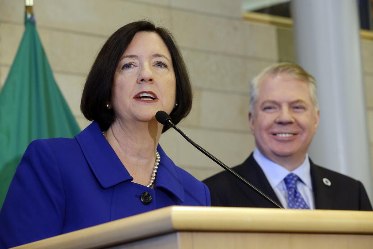 Former Boston police commissioner Kathleen O'Toole, left, speaks after being introduced by Seattle Mayor Ed Murray, right, as his nominee to be Seattle's new chief of police on Monday in Seattle.