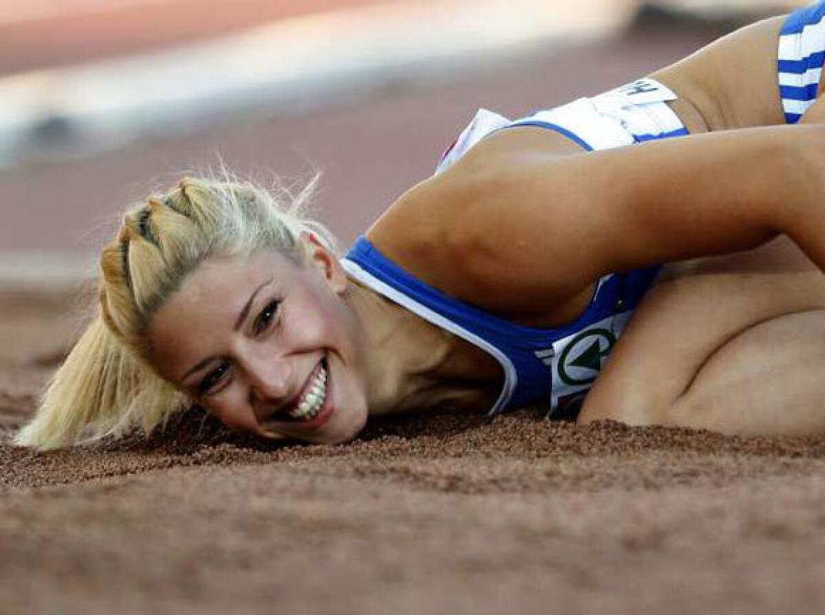 Greece's Voula Papachristou lands in the sand after her triple jump at the European Athletics Championships on June 29.