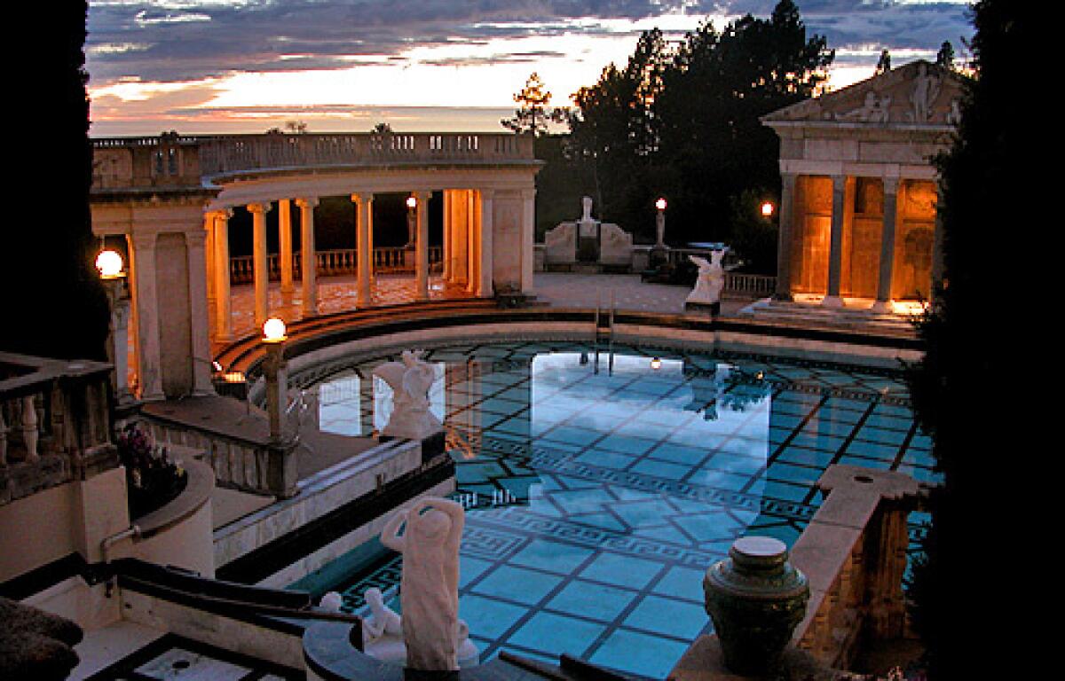 An evening tour at Hearst Castle in San Simeon, Calif., is popular among visitors, who can see the sun set behind the Neptune Pool.
