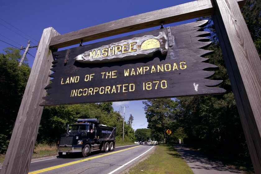 FILE - A wooden sign advises motorists of the location of Mashpee Wampanoag tribal lands, June 25, 2018, in Massachusetts. The tribe scored a major victory in its years long battle to preserve its reservation in December 2021, but it doesn't mean the Massachusetts tribe's path to building a resort casino on the sovereign lands has become any clearer. (AP Photo/Steven Senne, File)