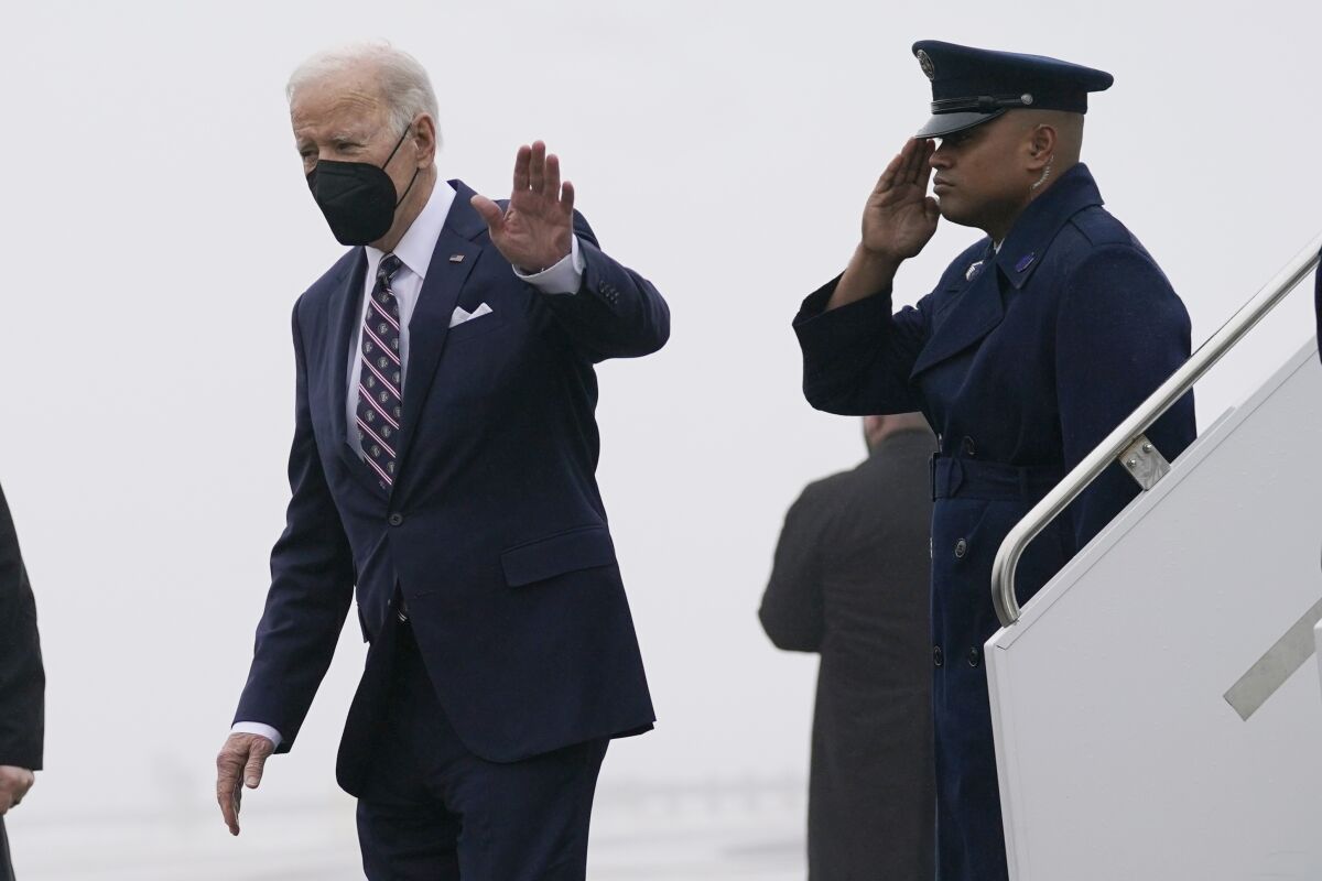 President Joe Biden waves as he steps off Air Force One.