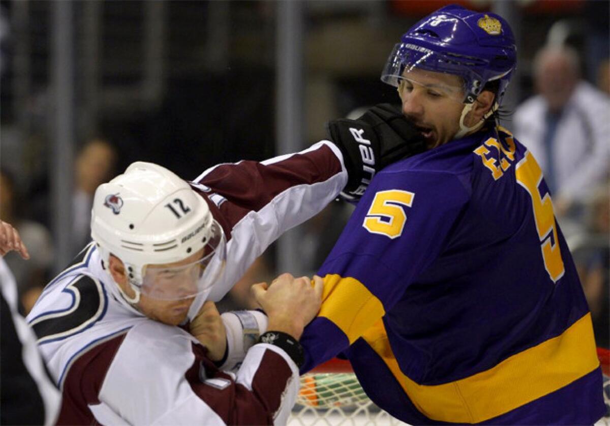 Kings defenseman Keaton Ellerby, right, fights Colorado Avalanche right wing Chuck Kobasew.