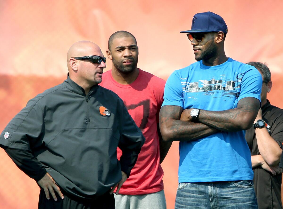 Cleveland Cavalier LeBron James, right, talks with Cleveland Brown Coach Mike Pettine on Thursday.