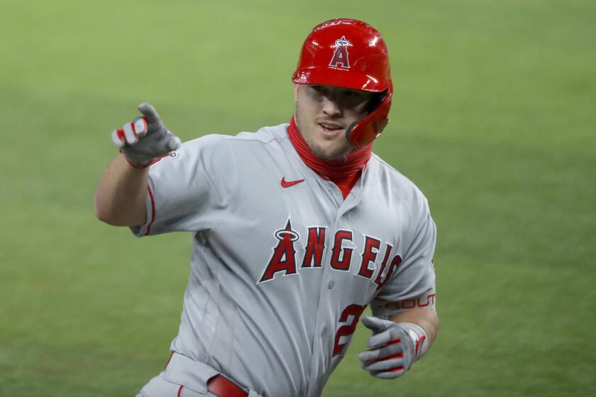 Los Angeles Angels' Mike Trout waves to the dugout after hitting a two-run home run.