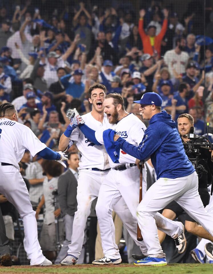Dodgers Max Muncy's, second from right, celebrates his walk-off home run against the Red sox in the bottom of the 18th inning.