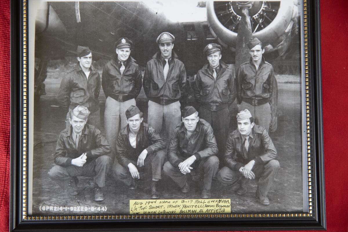 A black and white photo dated August 1944 shows several airmen posing with a B-17 aircraft.