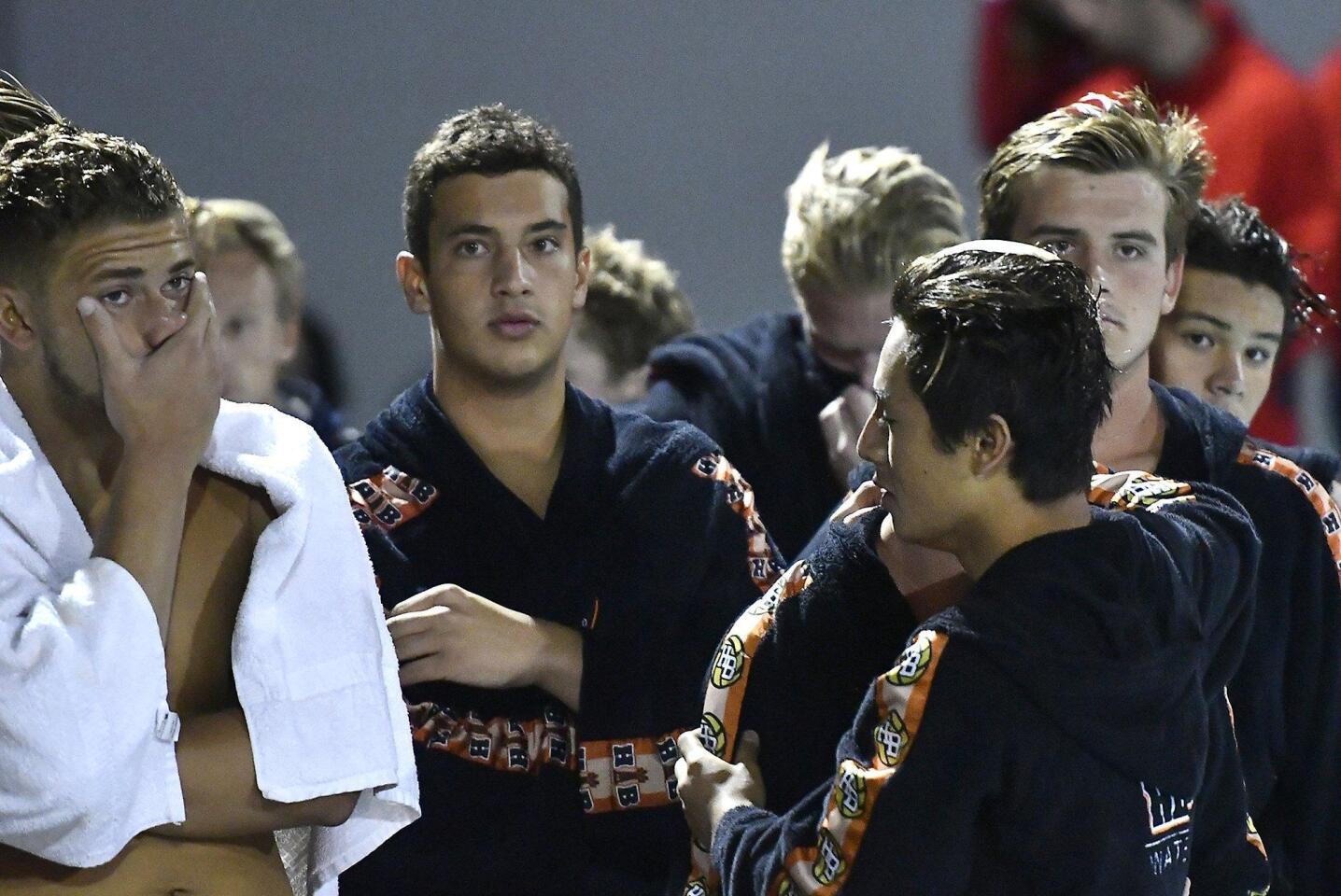 Huntington Beach High boys’ water polo players show their frustration after losing to Orange Lutheran 7-9 in the CIF Southern Section Division 1 championship game at Woollett Aquatics Center in Irvine on Saturday.