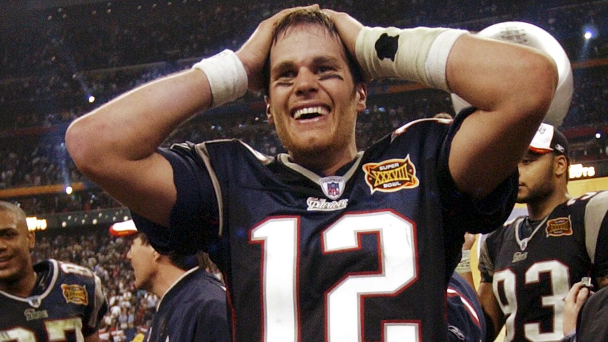 Quarterback Tom Brady celebrates after New England beat Carolina in Super Bowl XXXVIII in February 2004.