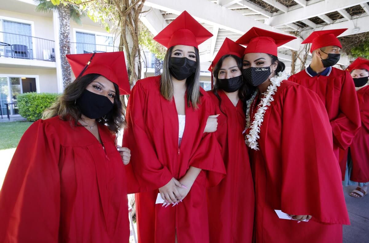 Students stop for a photo Thursday, June 10, 2021, at the Back Bay/Monte Vista High School commencement in Newport Beach.