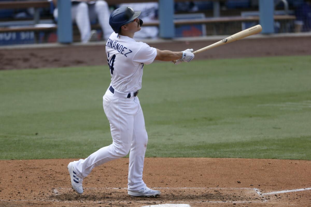 The Dodgers' Kiké Hernández follows through on a three-run home run.
