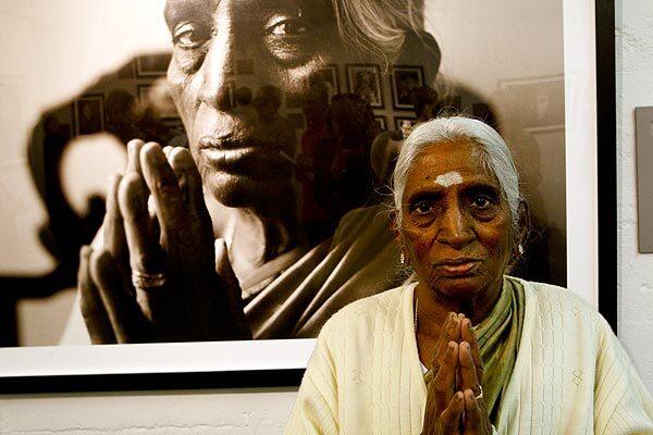 Mariyayee Chidambaram, 80, who was born in India and immigrated to the United States in 1982, poses with her portrait. See full story