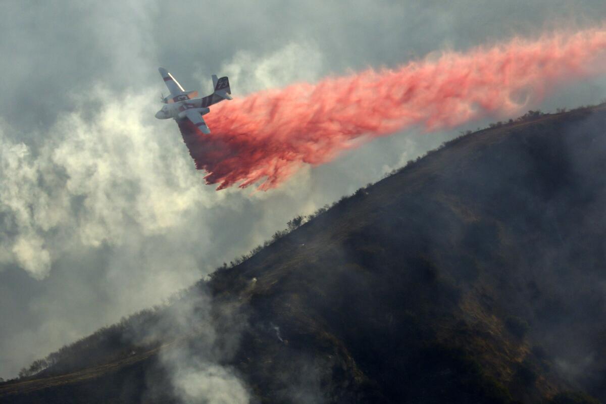 An airplane drops retardant on the Canyon 2 fire.