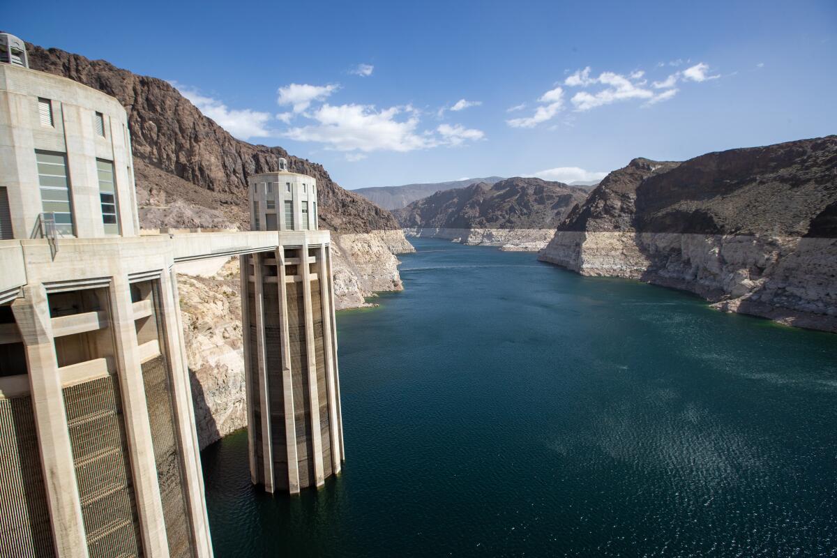 Concrete intake towers revealed by receding Lake Mead behind Hoover Dam in Nevada.